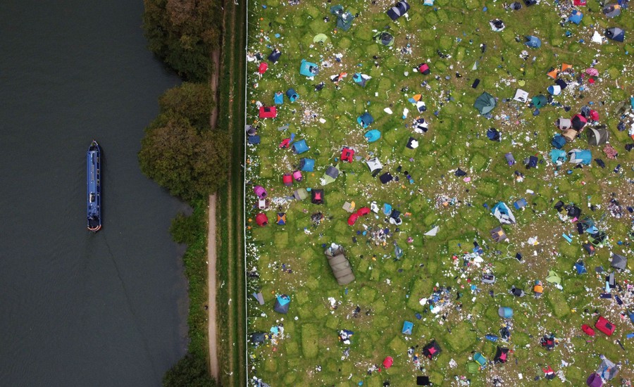 An aerial view of abandoned tents left in a field.