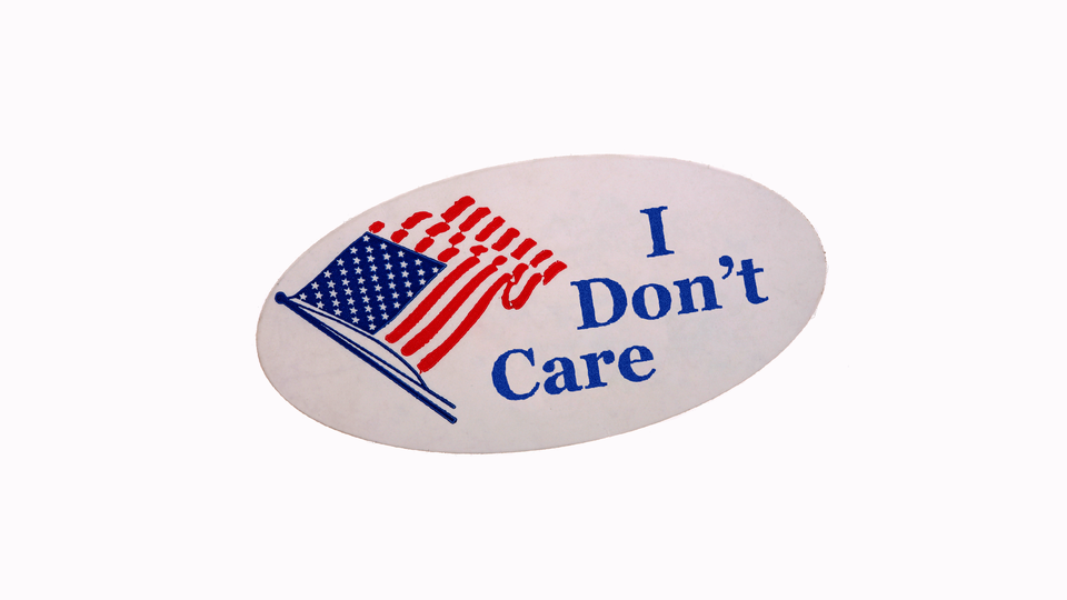 An oval sticker with an American flag and the words "I don't care" in blue