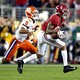 Two college football players mid-game