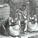 A man reads a Bible to two women in what looks like a barn.