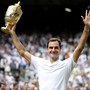 Roger Federer shows off his Wimbledon trophy.