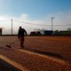A worker spreads out coffee beans to be dried in the sun on a farm in Guaxupe, Minas Gerais state, Brazil, on Wednesday, June 2, 2021