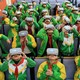A group of kids in green and yellow school uniforms wearing VR headsets