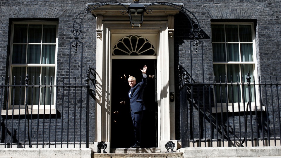 Boris Johnson walks through the door at Number 10 Downing Street.