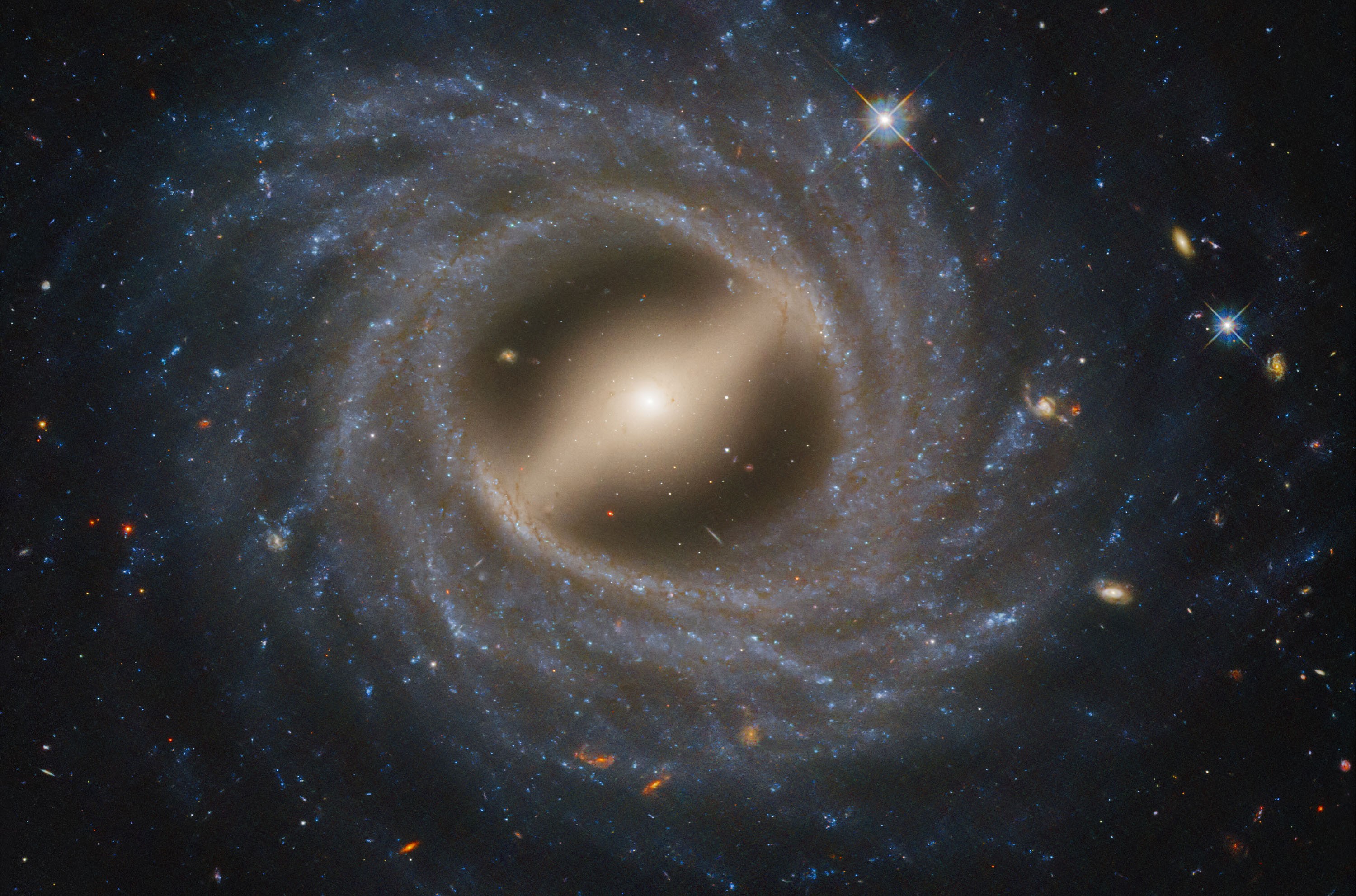 A face-on view of a spiral galaxy, showing a well-defined bar-like structure spanning its center