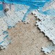 A blue and white puzzle on a beige surface that also has a puzzle imprint