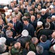 Assad stands in the middle of a throng of supporters, who greet him after Eid al-Fitr prayers at a mosque in Tartous.