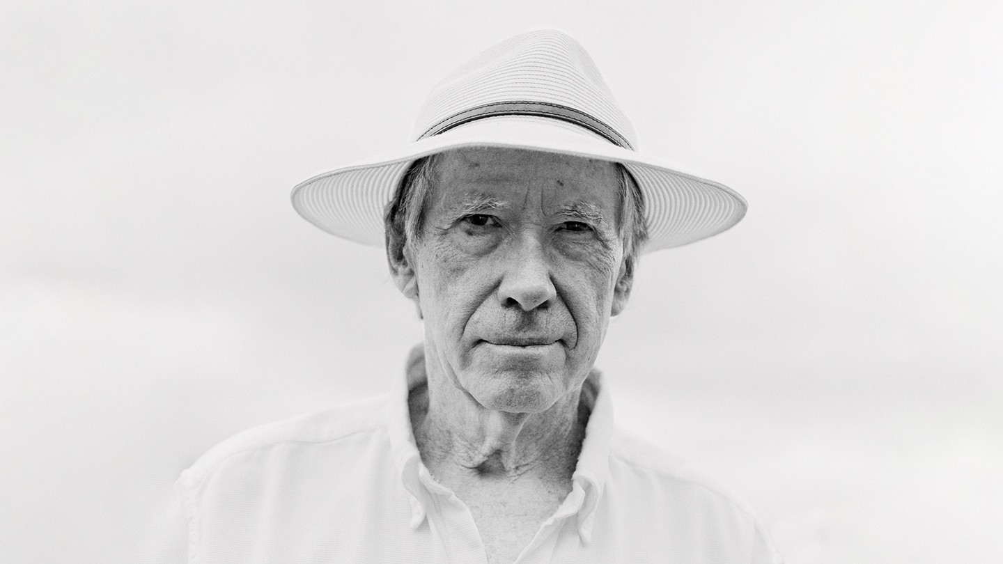 black and white photo of Ian McEwan wearing straw fedora and white collared shirt