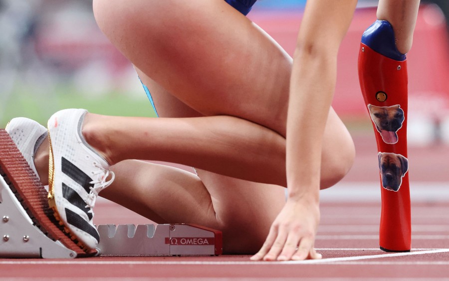 An athlete sets herself up in the starting blocks for a race.