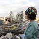 A child looks at a building destroyed by U.S. air strikes in Yemen