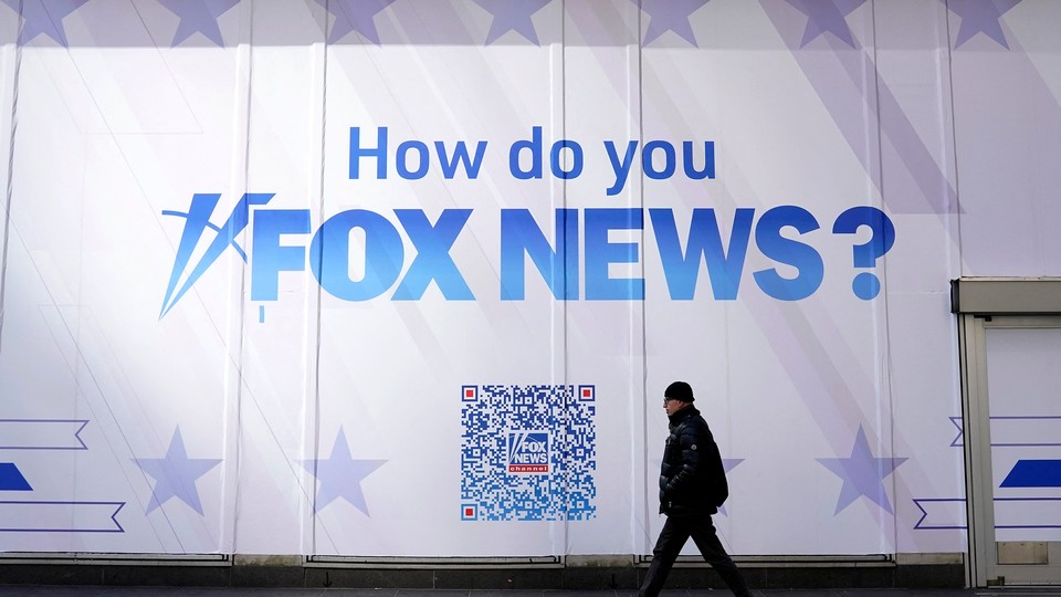A person walks past the Fox News headquarters at the News Corp building in New York City on March 9, 2023.