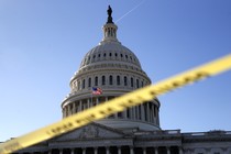 The Capitol dome framed by yellow police tape