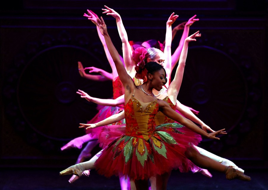 Ballet dancers rehearse together onstage.