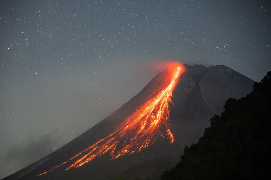 Lava runs down from the crater of a volcano.