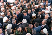 Assad stands in the middle of a throng of supporters, who greet him after Eid al-Fitr prayers at a mosque in Tartous.