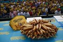 People wearing hot-dog hats attend the Annual Nathan's Hot Dog Eating Contest in 2018 in Coney Island