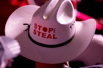An image of a man in a cowboy hat that says "Stop the Steal" on it.