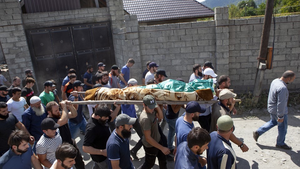 Mourners carry the body of a Chechen dissident in Duisi village, the Pankisi Gorge valley, in Georgia.