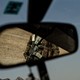 A soldier appears in a rear view mirror