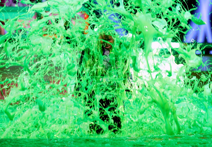 A man is doused in gallons of green slime.
