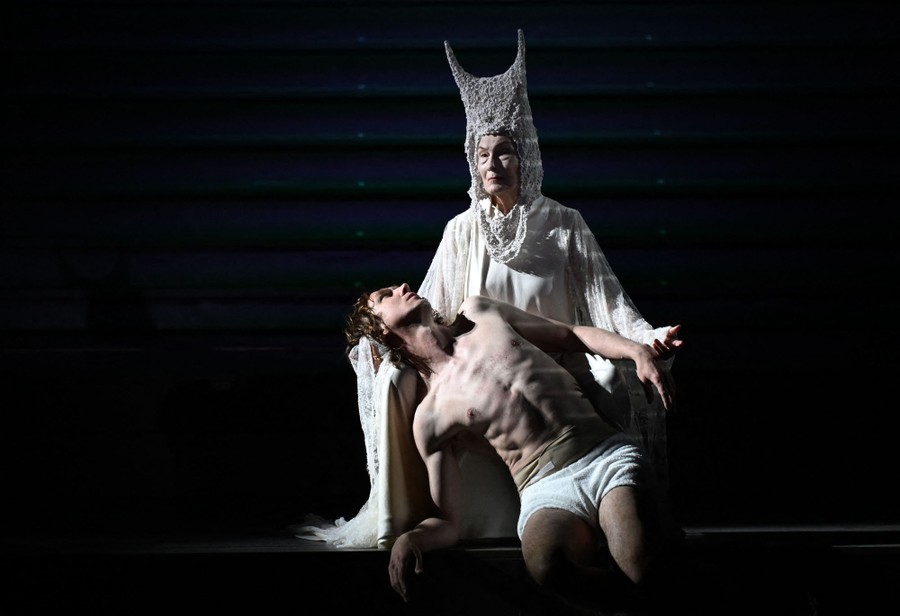 Two performers are seen on stage.