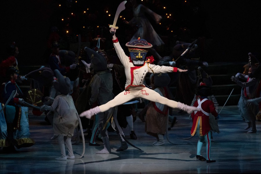People in costume perform onstage, dressed as mice, toy soldiers, and a nutcracker.