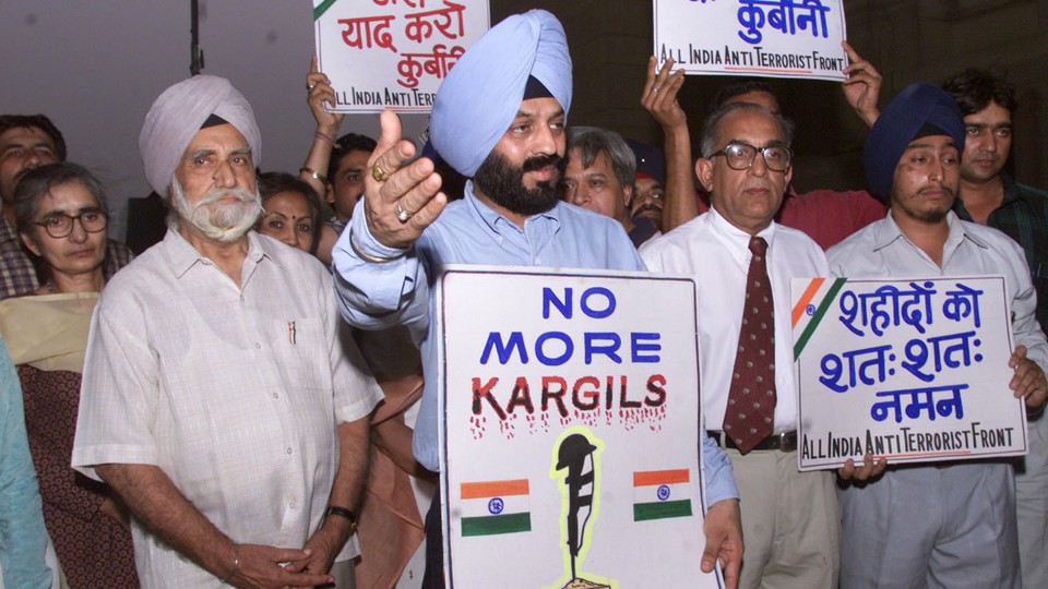 Family members and friends of Indian soldiers killed in the Kargil conflict gather on the conflict's first anniversary, in 2000.