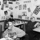 A black-and-white photo of people eating by themselves in a restaurant