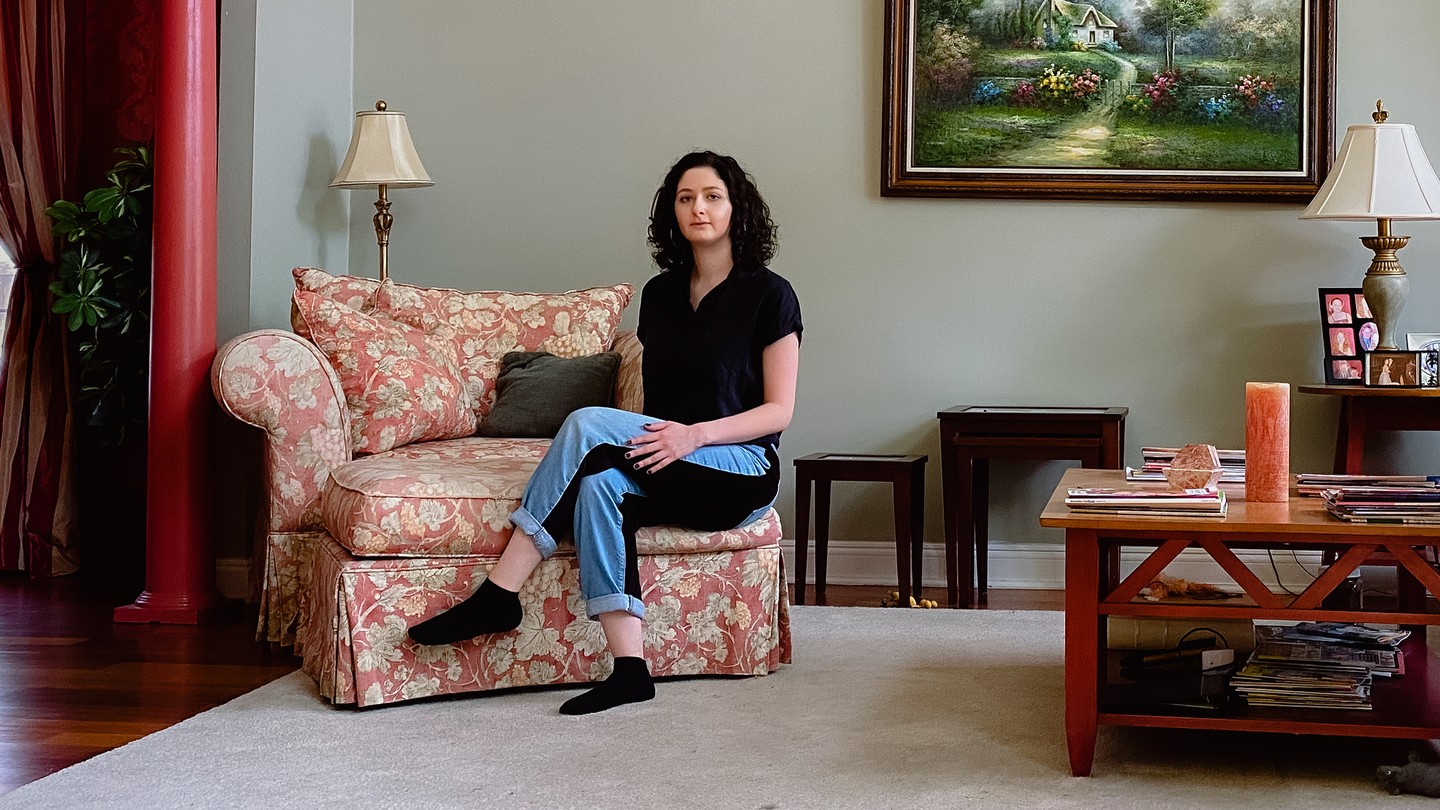 A young woman sitting in an armchair