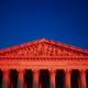 The Supreme Court in a reddish hue.