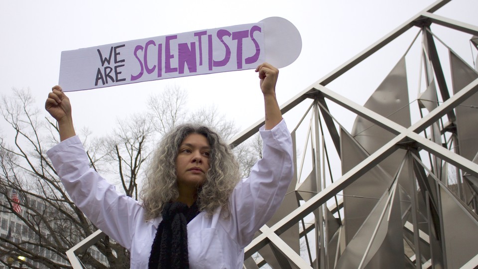 Dr. Yamilé Molina holds a sign saying ‘We Are Scientists’ during the Women’s March on Washington on Saturday, January 21, 2017. She stands next to the “Solar Delta” outdoor sculpture at the National Air and Space Museum.