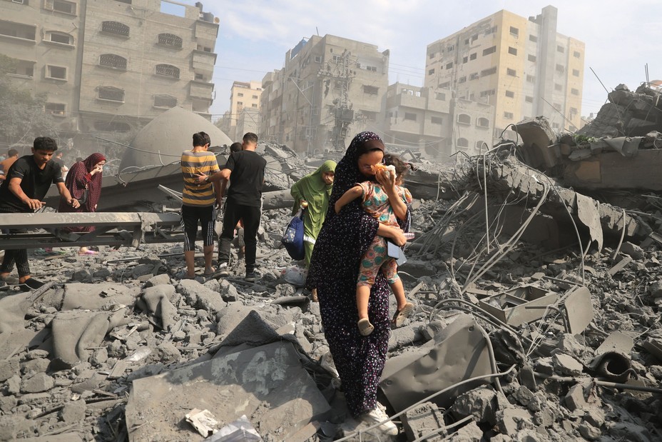 Picture of Palestinians evacuating the area following an Israeli airstrike on the Sousi mosque in Gaza City on October 9, 2023. 