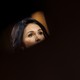Tulsi Gabbard's face, mostly exposed by a dark blur