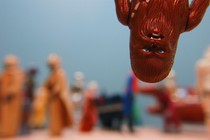 Upside-down Chewbacca figurine in foreground; other, blurry figurines in background