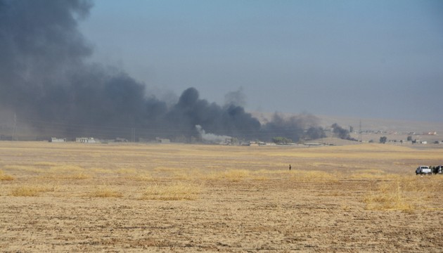 Smoke rises from clashes at Bartila in the east of Mosul during clashes with Islamic State militants.