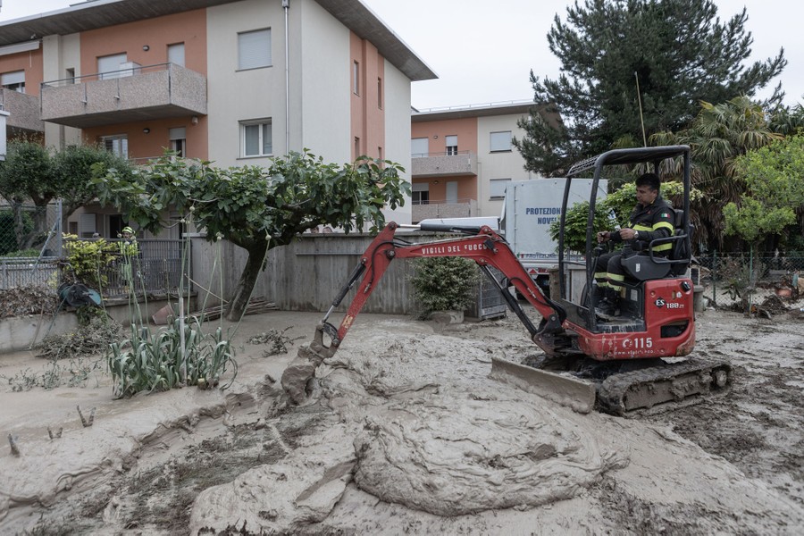 A small excavator is used to remove sloppy mud.