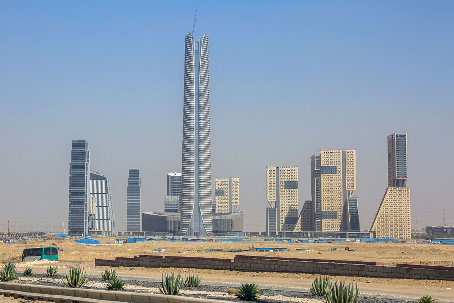 A view of a cluster of about nine or 10 tall buildings in the desert