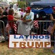A Latinos Vote For Trump sign outside of a Trump rally.