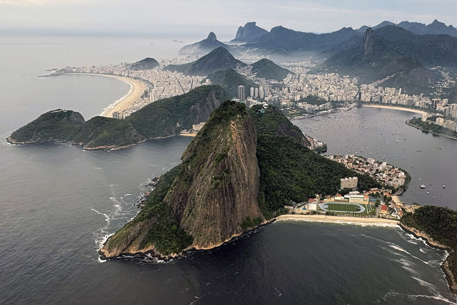 An aerial view of the mountains, harbors, and buildings of Rio de Janeiro