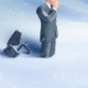 Illustration of a man in a suit buried up to his knees in snow