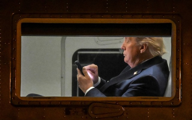 Photograph of Trump typing on a smartphone
