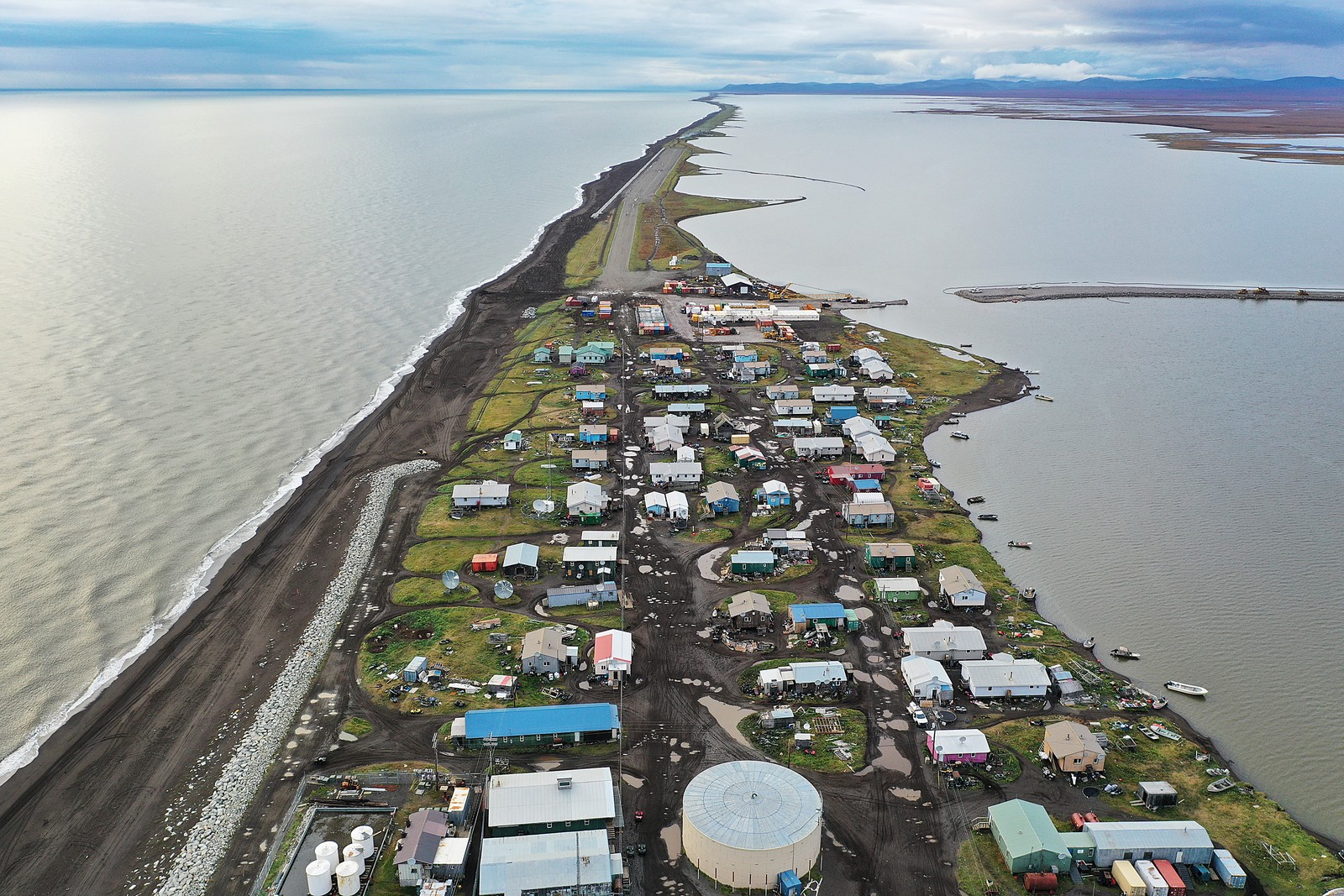 An aerial view of an Alaskan village on a long and narrow spit of land