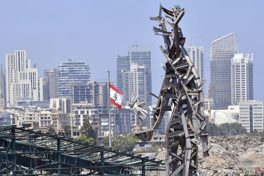 A view of a 25-meter-tall steel sculpture, shaped like a giant holding out a flower.