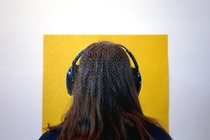 The back of a person's head with headphones