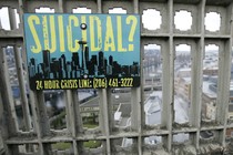 A sign advising of the phone number for a suicide-prevention hotline is shown on the Aurora Bridge in Seattle.
