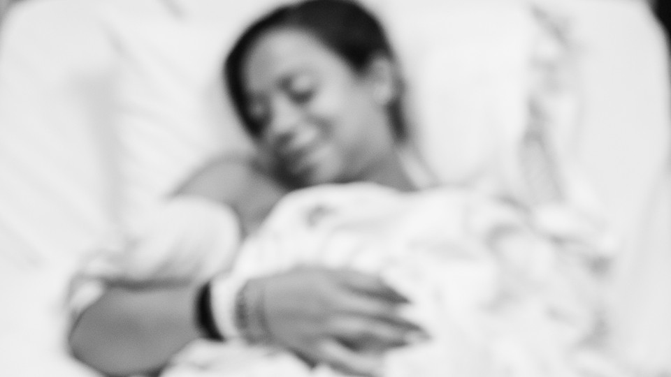 A Black mother holding her newborn