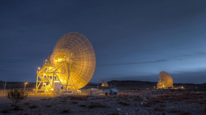 Large satellites in the desert at night
