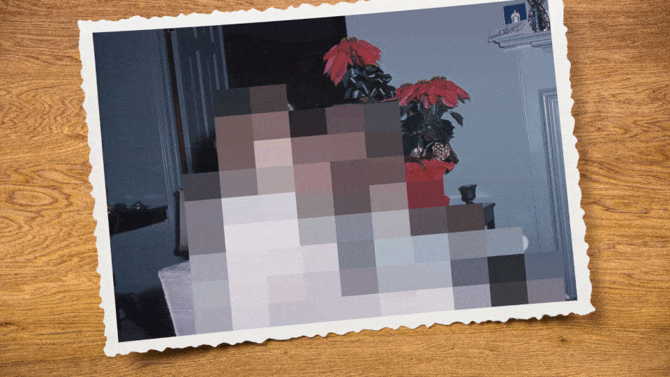 A family sitting on a couch comes into focus from a pixelated view.