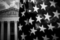 A photo showing an American flag in the foreground and the Supreme Court in the background