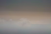 a cloudy beige sky, darker at the top of the image and lighter in the middle